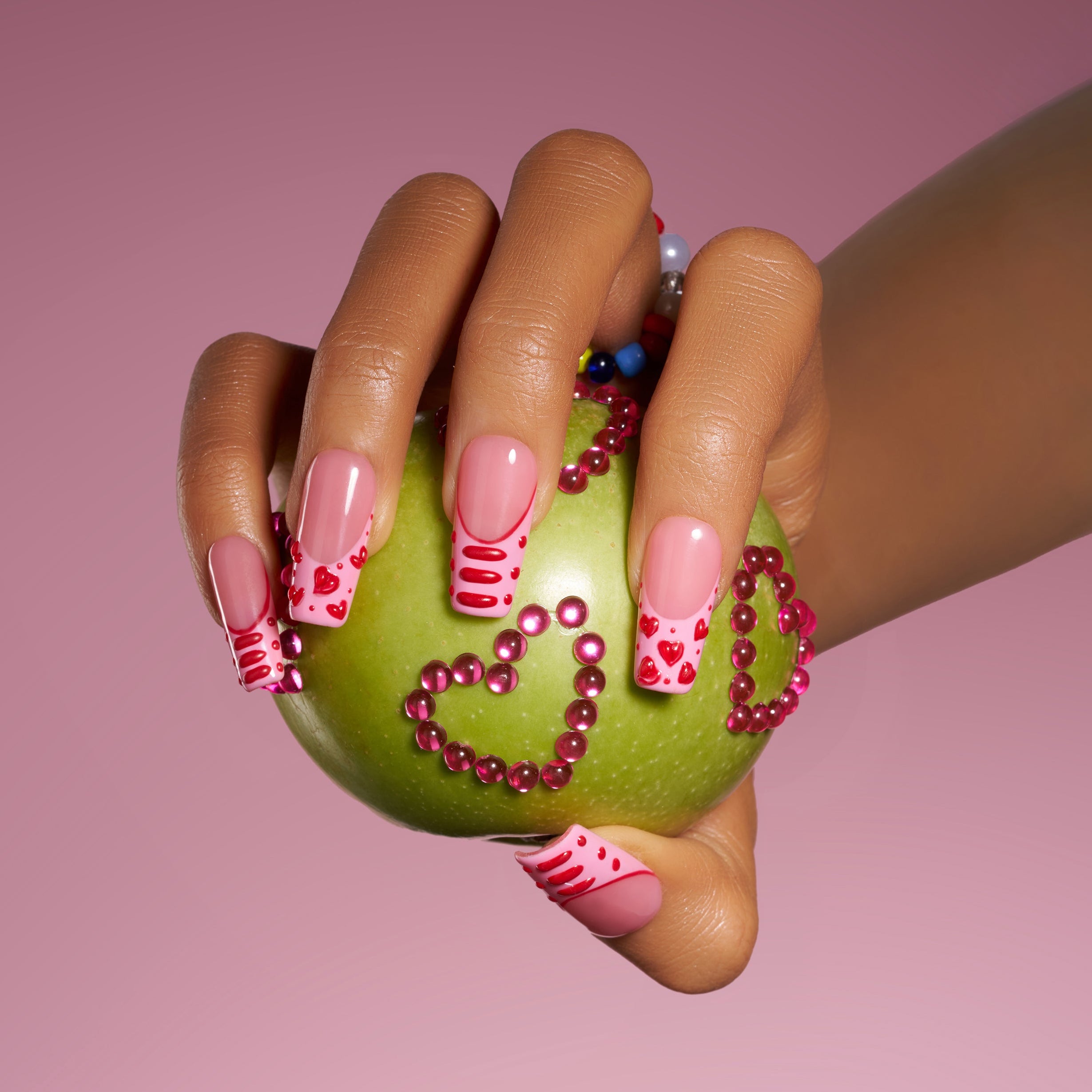 Sweet peach press on nails with 3D heart details. Romantic glossy finish and reusable comfort fit.