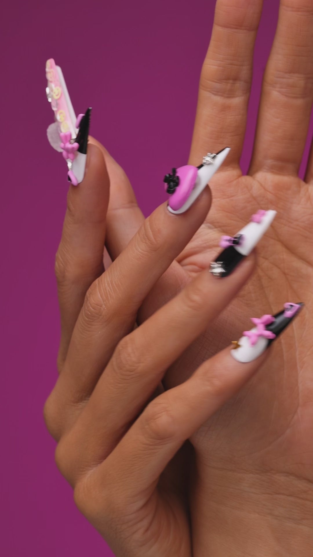 Bold black and white stiletto press on nails with 3D heart accents. Reusable statement nail set.
