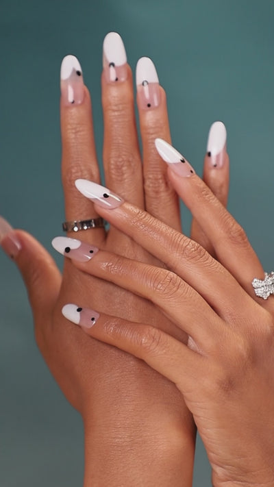 Minimal nude press on nails with black dot detail. Modern monochrome manicure set.