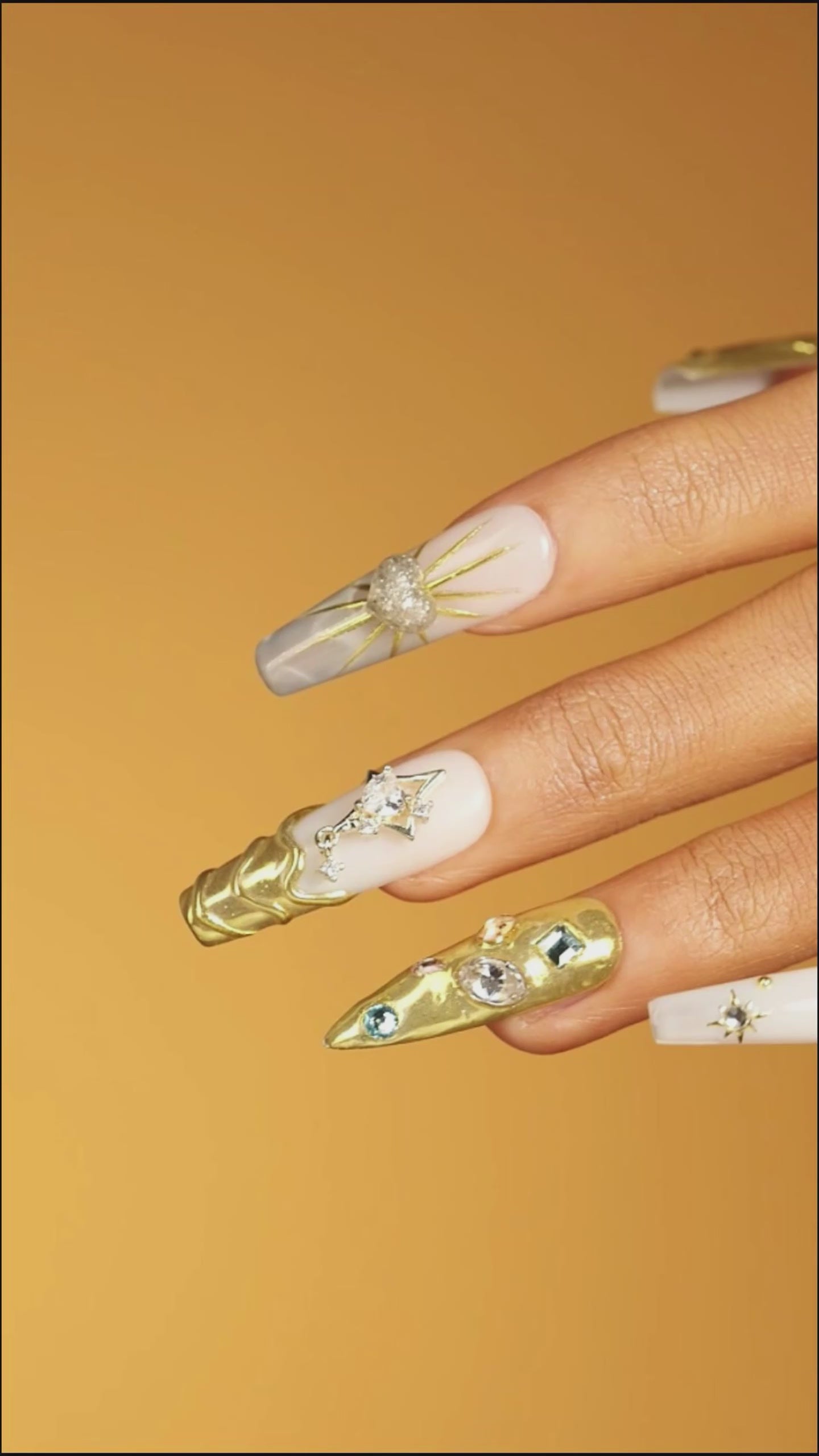 Luxury gold chrome press on nails with crystal details. High shine, sculpted texture and reusable glam design.