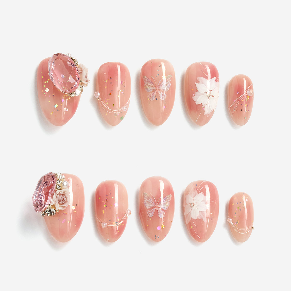 Peach butterfly press on nails with crystal accents and glossy shimmer finish.