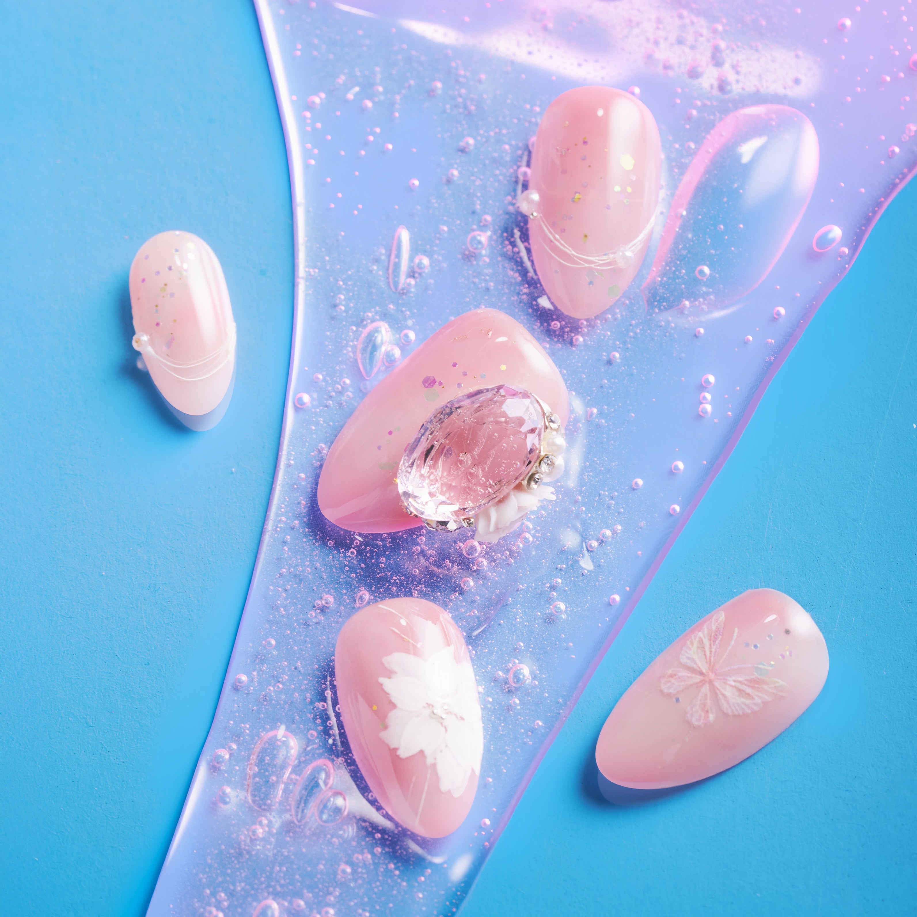 Peach butterfly press on nails with crystal accents and glossy shimmer finish.