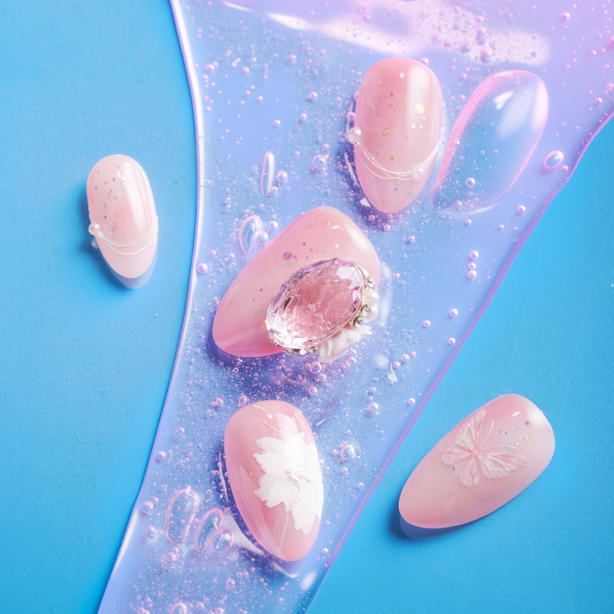 Peach butterfly press on nails with crystal accents and glossy shimmer finish.