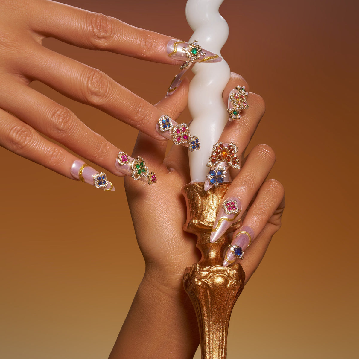 Luxury press on nails with gemstone embellishments and metallic base. Reusable high-end statement nail set.
