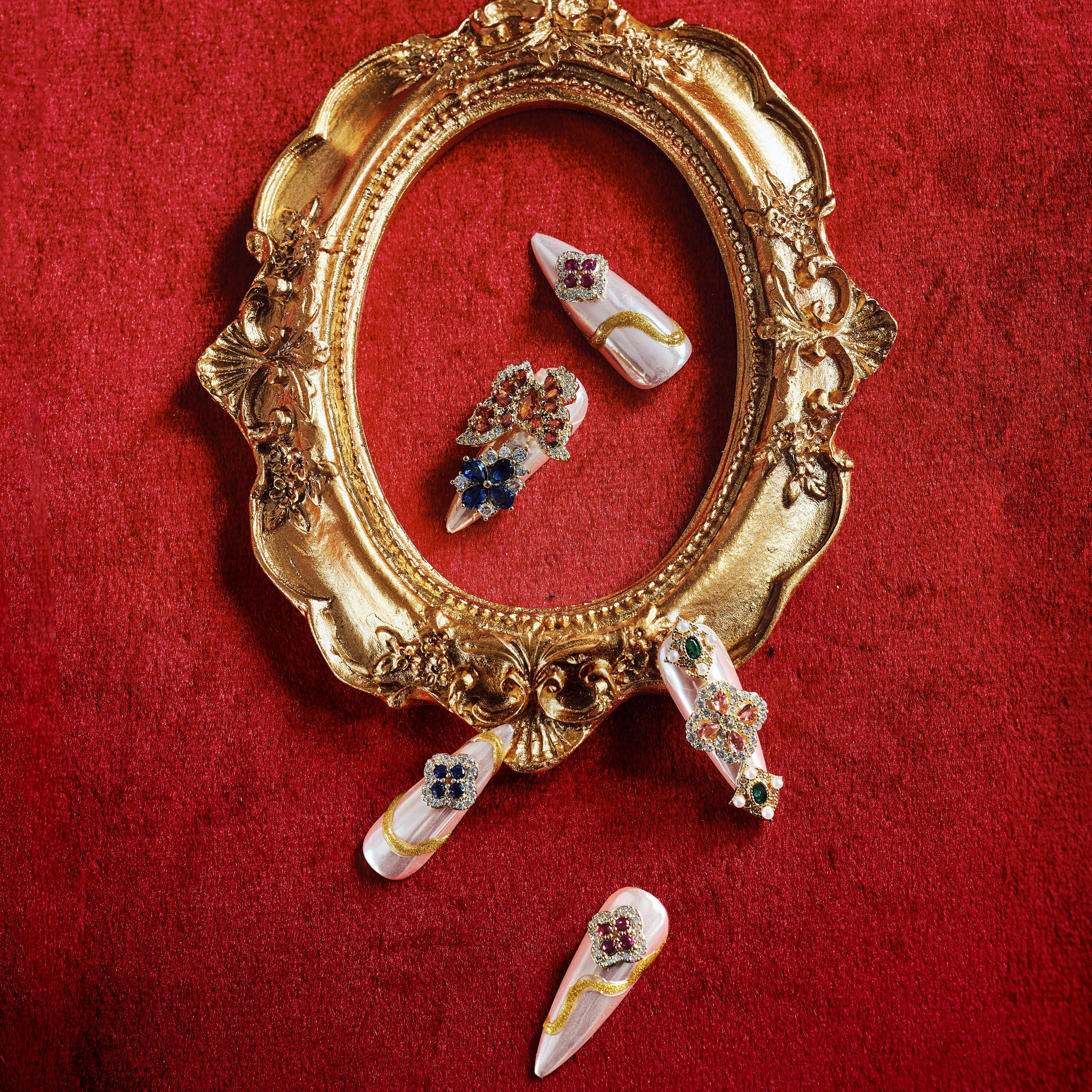 Luxury press on nails with gemstone embellishments and metallic base. Reusable high-end statement nail set.