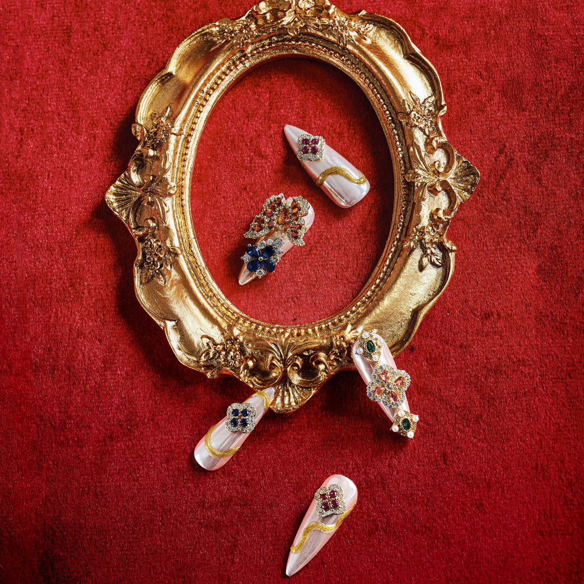 Luxury press on nails with gemstone embellishments and metallic base. Reusable high-end statement nail set.