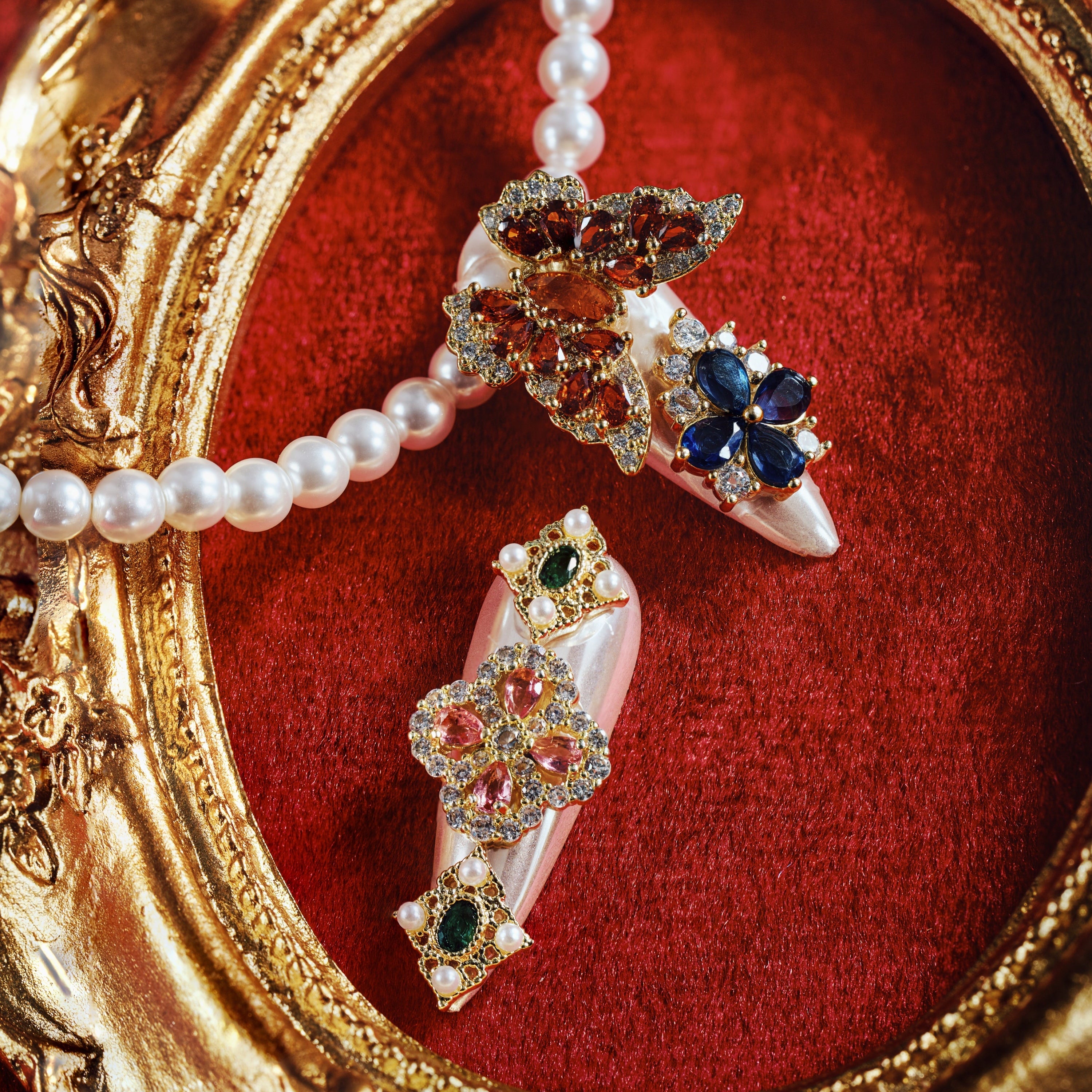 Luxury press on nails with gemstone embellishments and metallic base. Reusable high-end statement nail set.