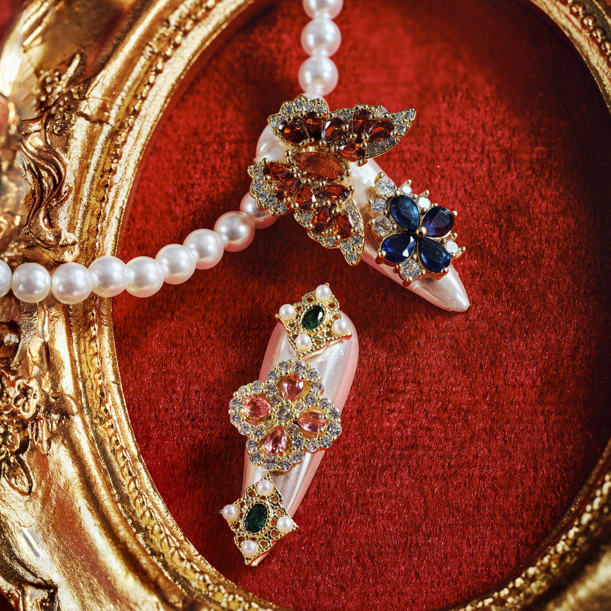 Luxury press on nails with gemstone embellishments and metallic base. Reusable high-end statement nail set.