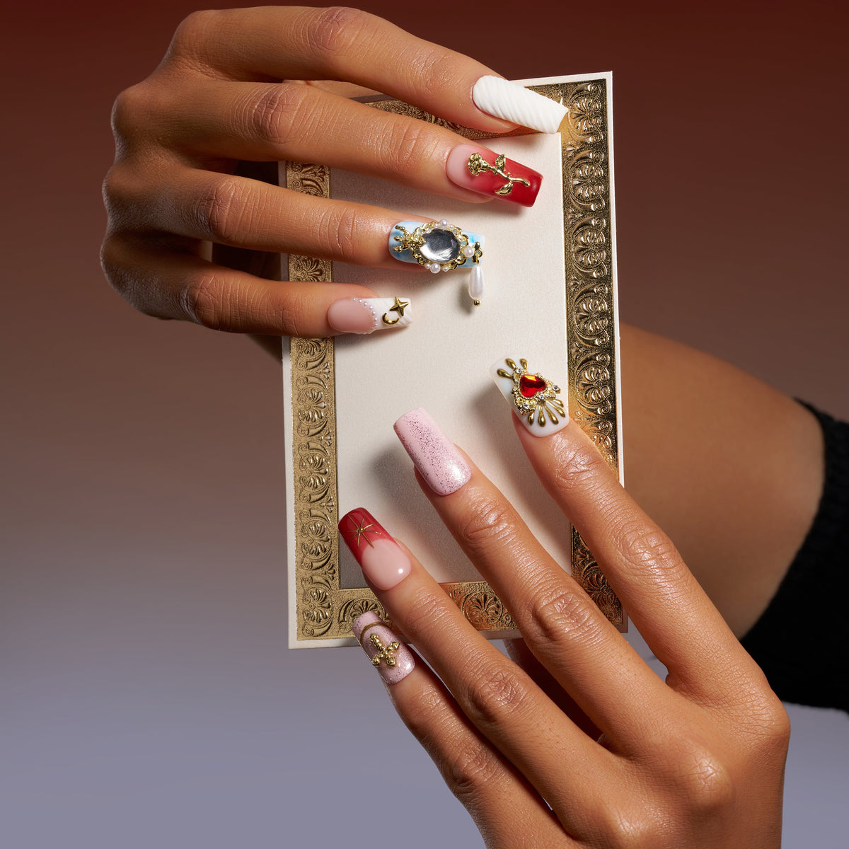 Baroque-inspired luxury press on nails with ornate gold accents and sacred heart details.