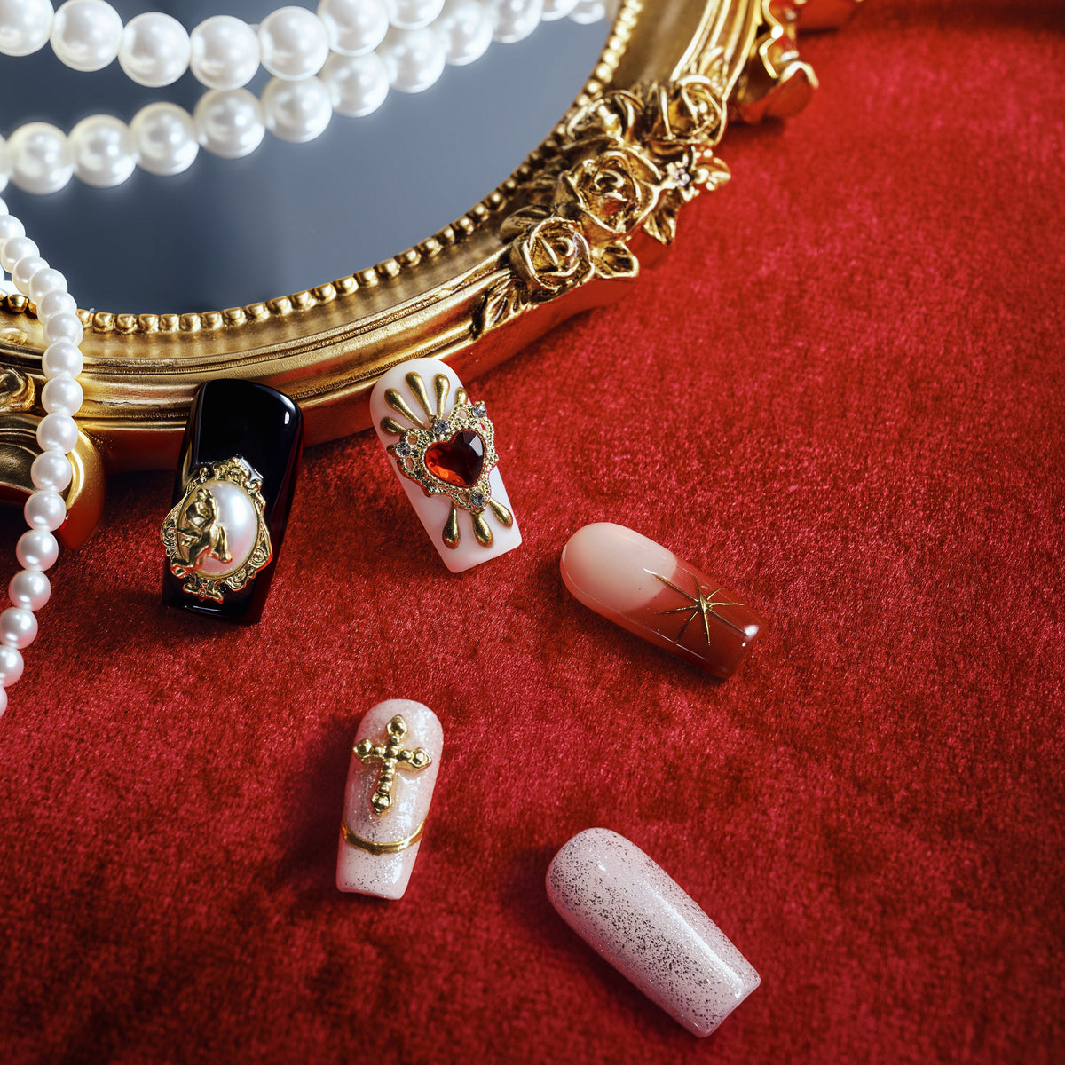 Baroque-inspired luxury press on nails with ornate gold accents and sacred heart details.