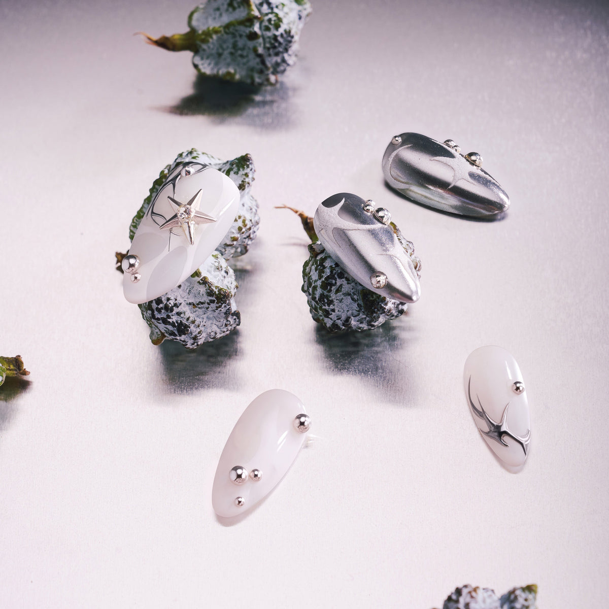 Silver Mystique metallic press on nails with abstract chrome textures.