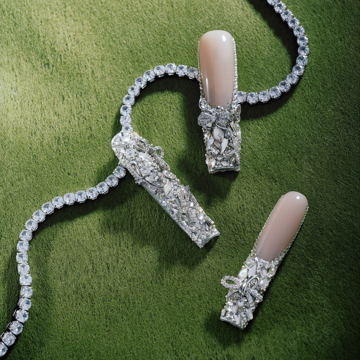 Silver Wing Shine long nude press on nails with heavy crystal embellishments.