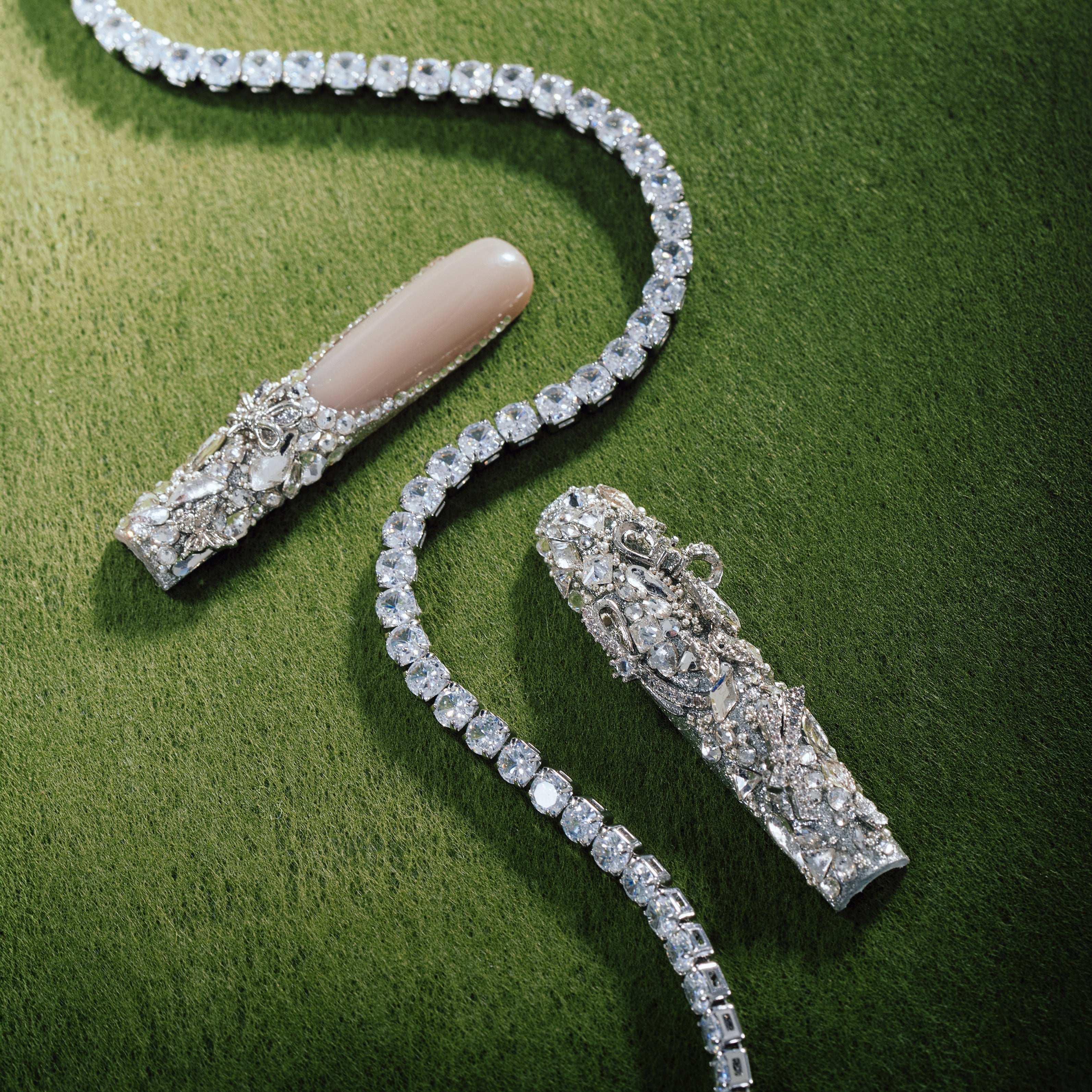 Silver Wing Shine long nude press on nails with heavy crystal embellishments.