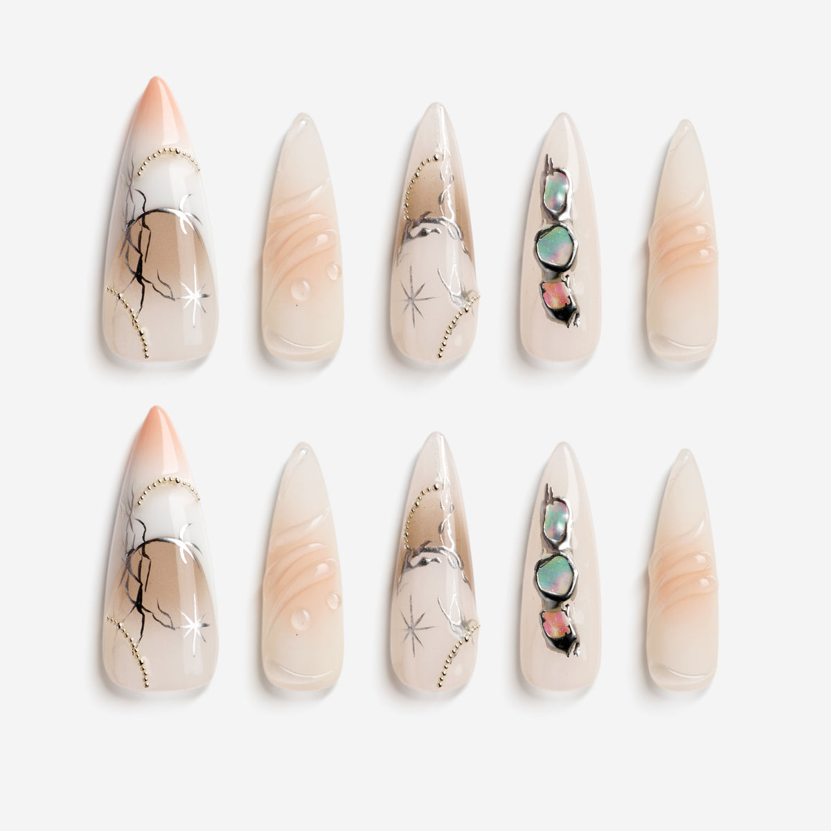 Snowfall Serenade nude stiletto press on nails with moon and star details.