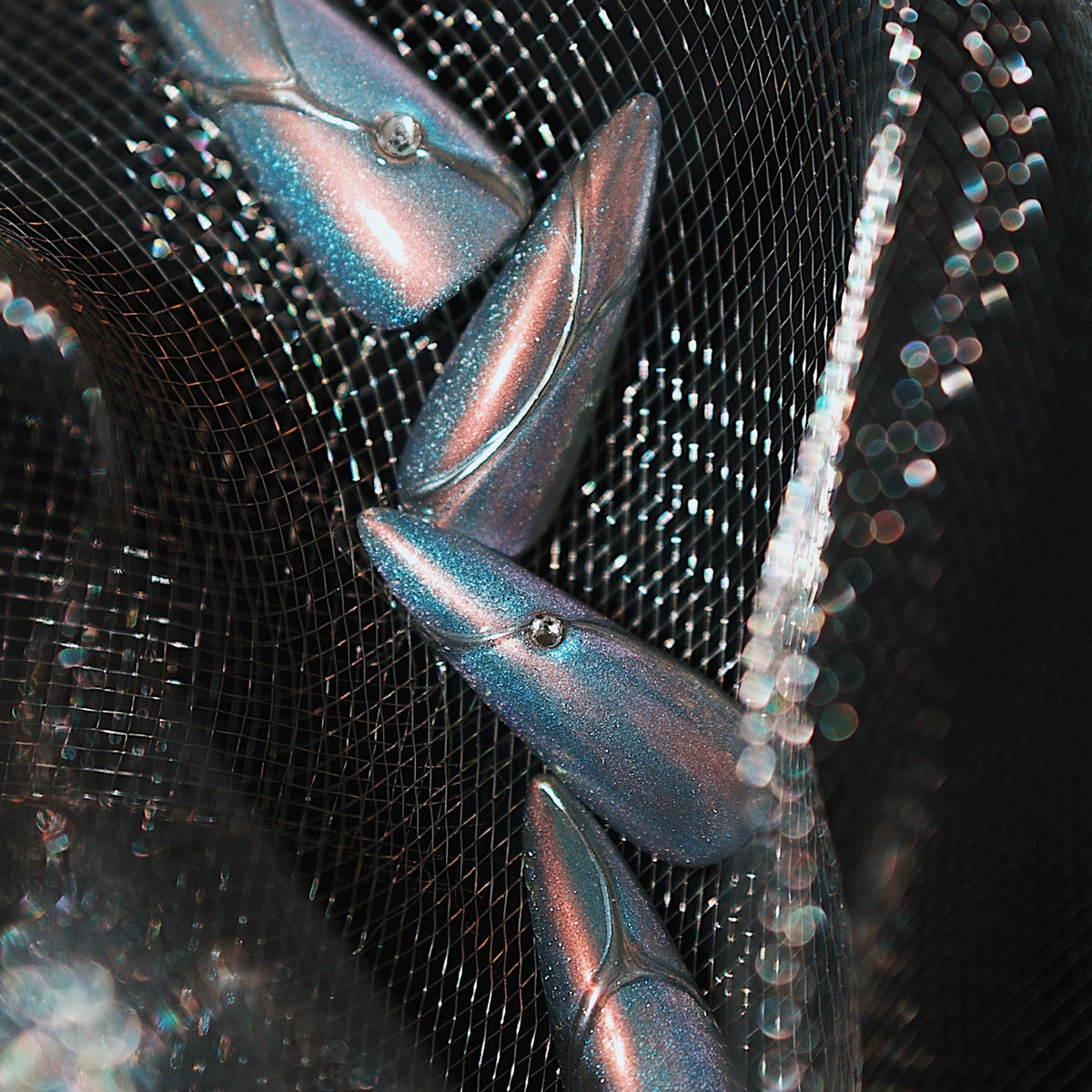 Holographic silver stiletto press on nails with metallic lines and minimalist chrome shine