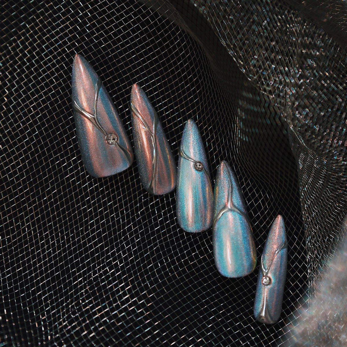 Holographic silver stiletto press on nails with metallic lines and minimalist chrome shine