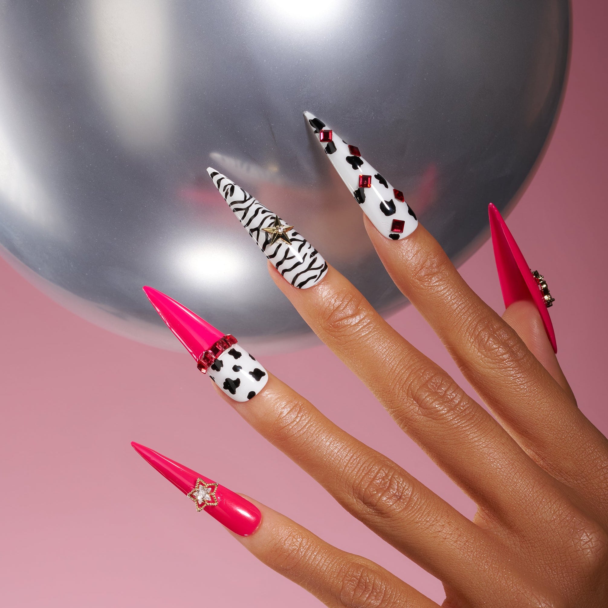 Bold pink press on nails with zebra and leopard accents plus crystal stars. Fun, edgy and reusable.