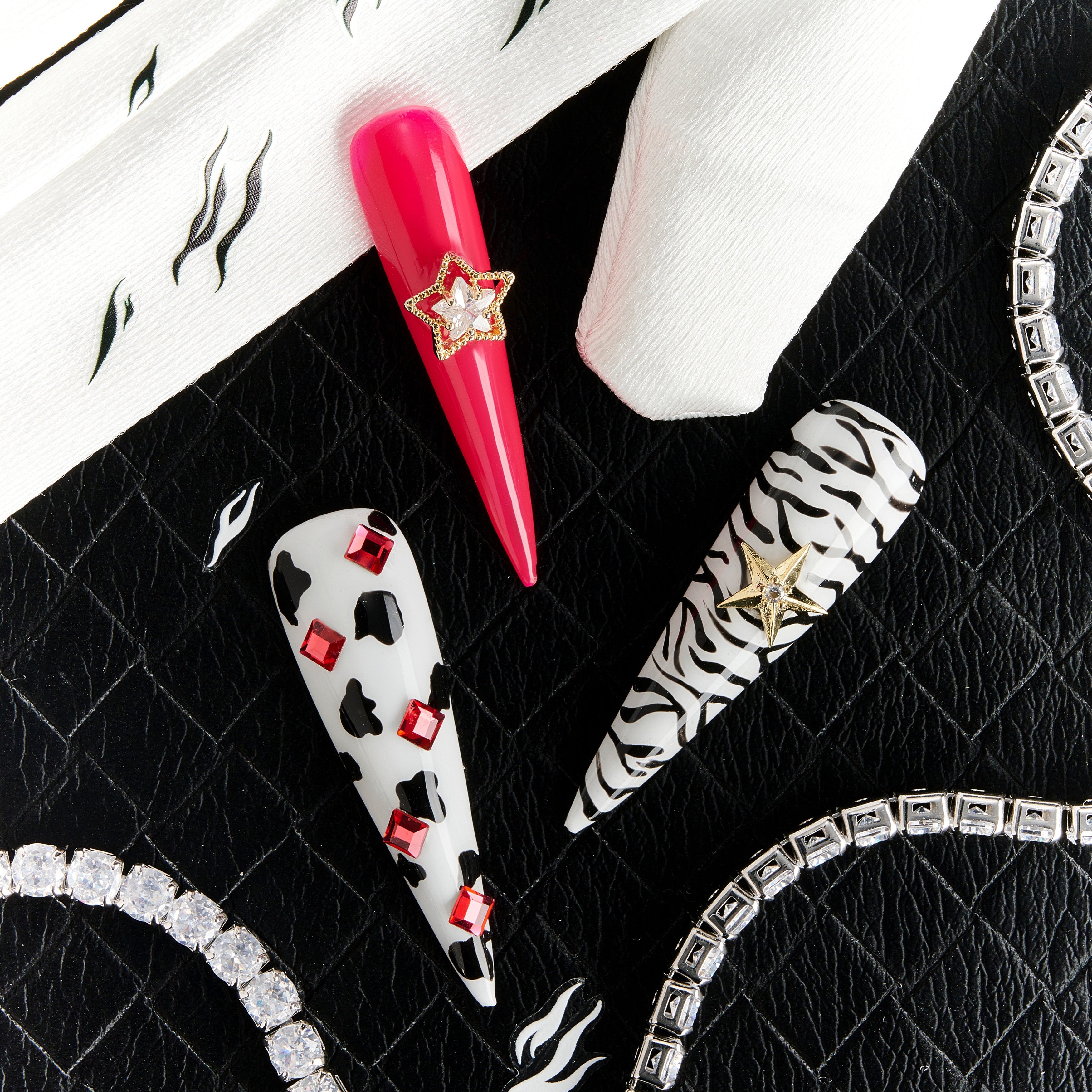 Bold pink press on nails with zebra and leopard accents plus crystal stars. Fun, edgy and reusable.