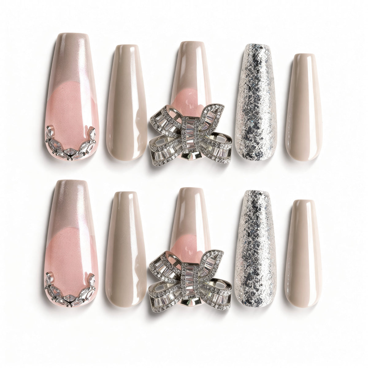 Pink and nude press on nails with silver glitter, rhinestones, and crystal bow charm